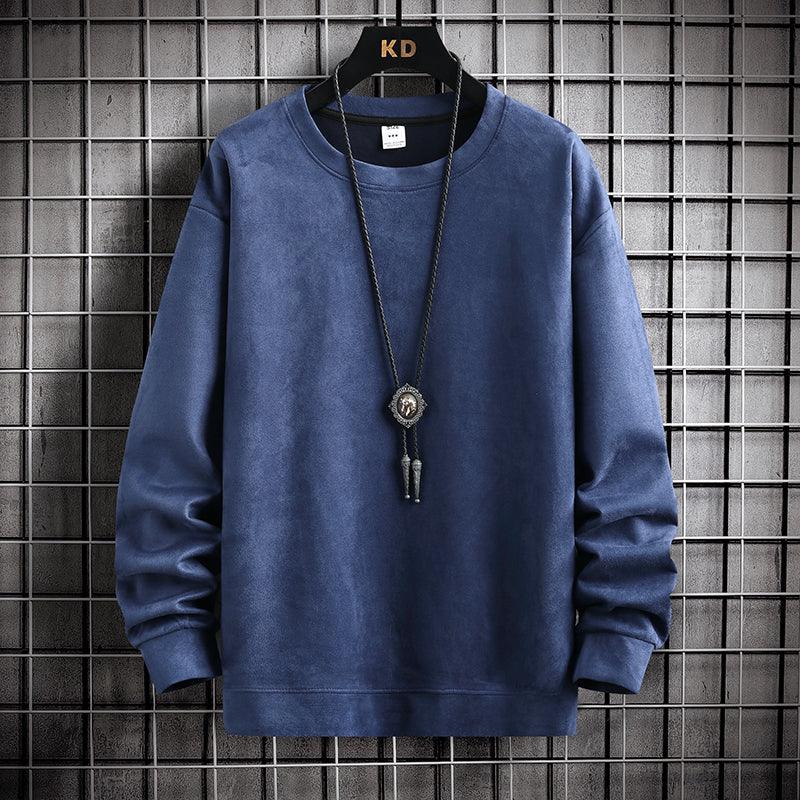 Blue long-sleeve crewneck sweatshirt hanging on KD hanger with black pendant necklace against metal grid wall