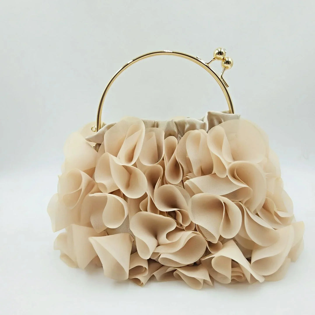 Beige ruffled fabric clutch bag with gold metal handle on white background