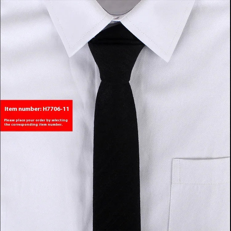 Close-up of a white dress shirt with a black slim necktie and a red label showing item number H7706-11