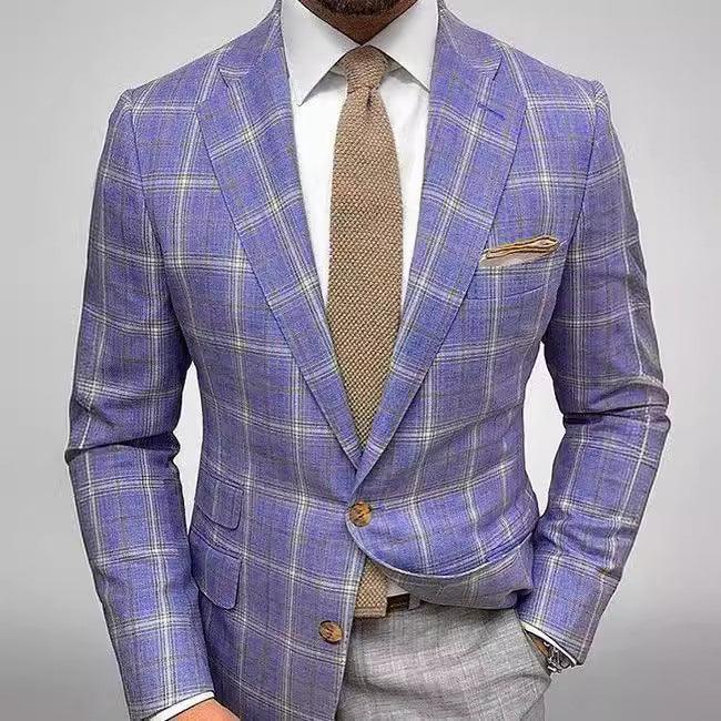 Man wearing a purple plaid blazer with brown buttons, white shirt, brown tie, and gray trousers