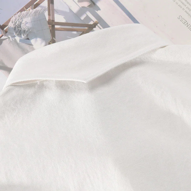 Close-up of white fabric clothing collar on top of a magazine with wooden chair image