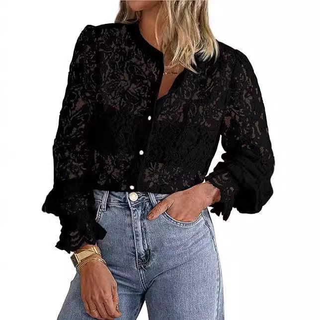 Woman wearing sheer black lace blouse with pearl buttons and puffed sleeves paired with high-waisted blue jeans