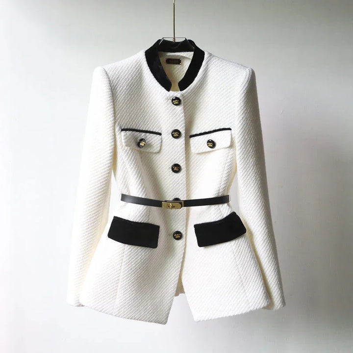 Elegant white textured blazer with black velvet collar, pockets, and gold buttons, styled with a black belt
