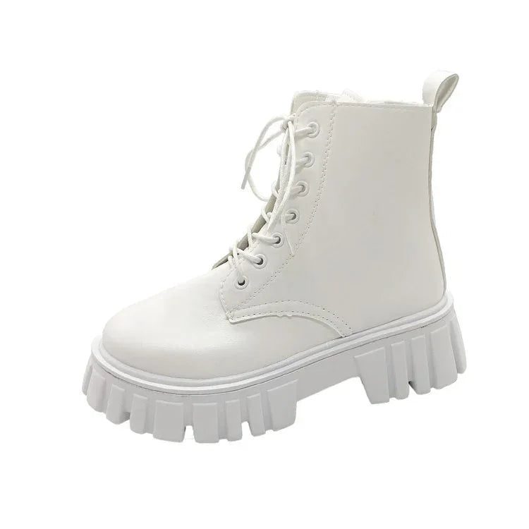 White chunky platform combat boot with lace-up front and pull tab on white background