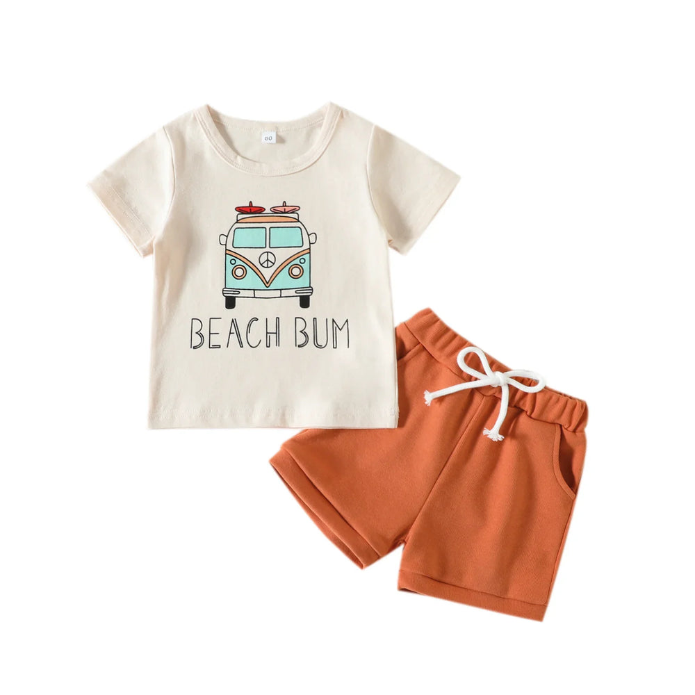 Kids two-piece summer outfit with cream t-shirt featuring beach bus graphic and terracotta shorts