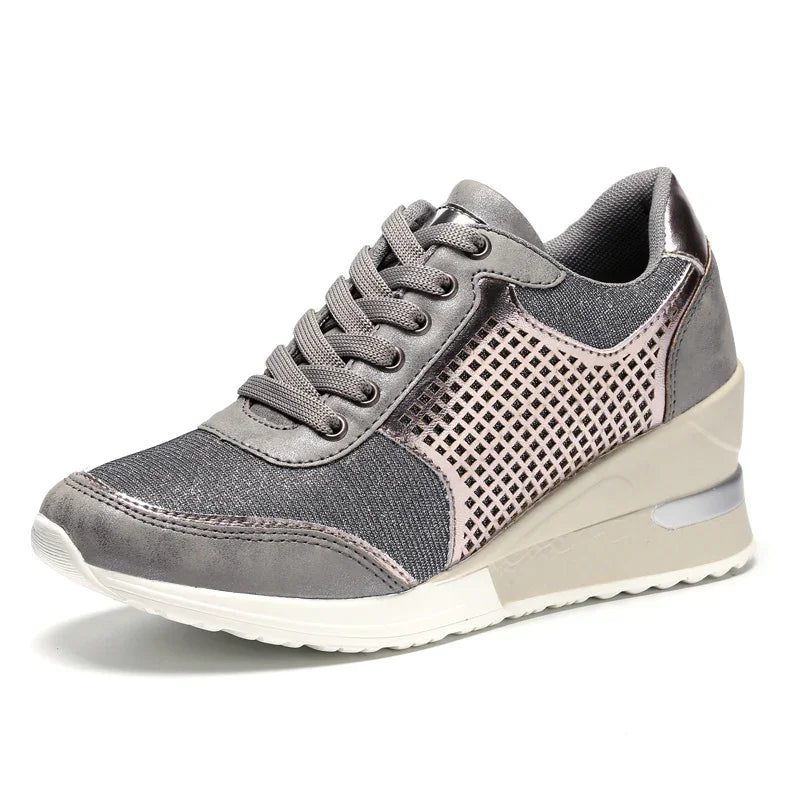 Gray wedge sneaker with mesh and perforated side design, white sole, and lace-up closure