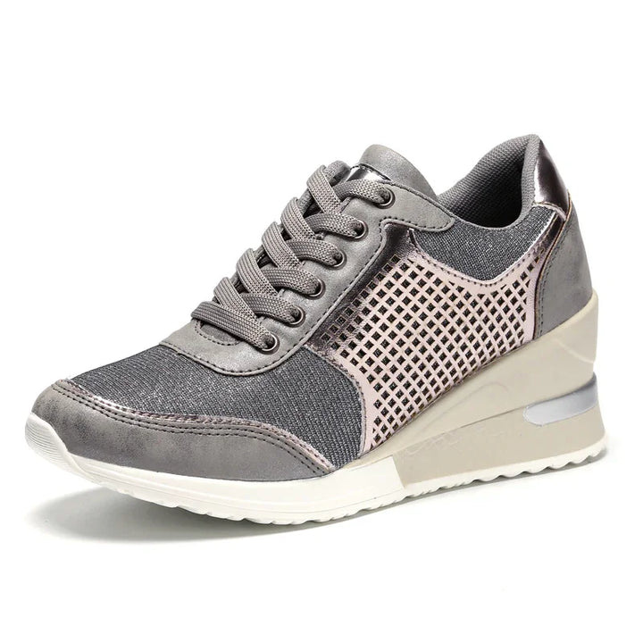 Gray wedge sneaker with mesh and perforated side design, white sole, and lace-up closure