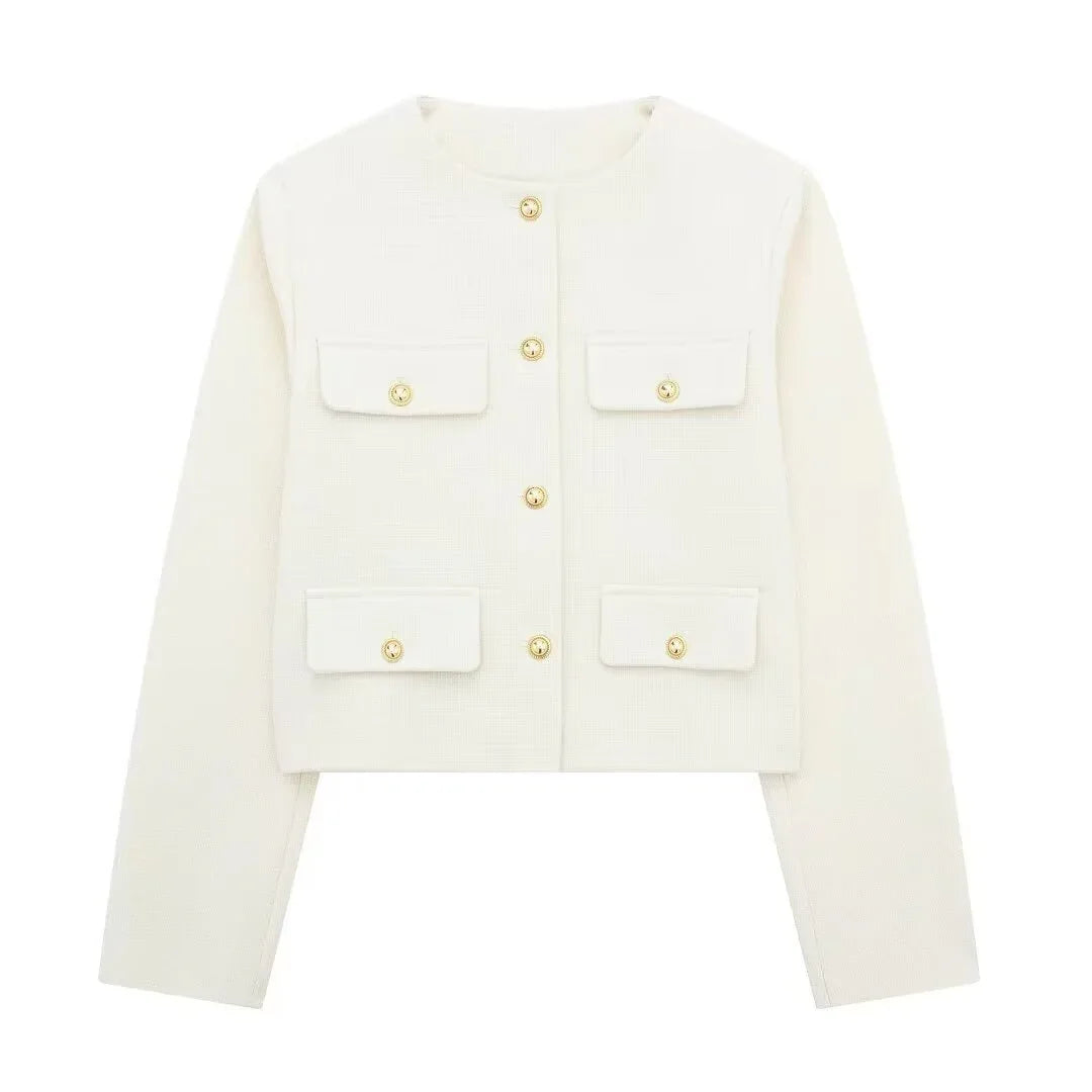 White cropped jacket with long sleeves, four front flap pockets, and gold buttons