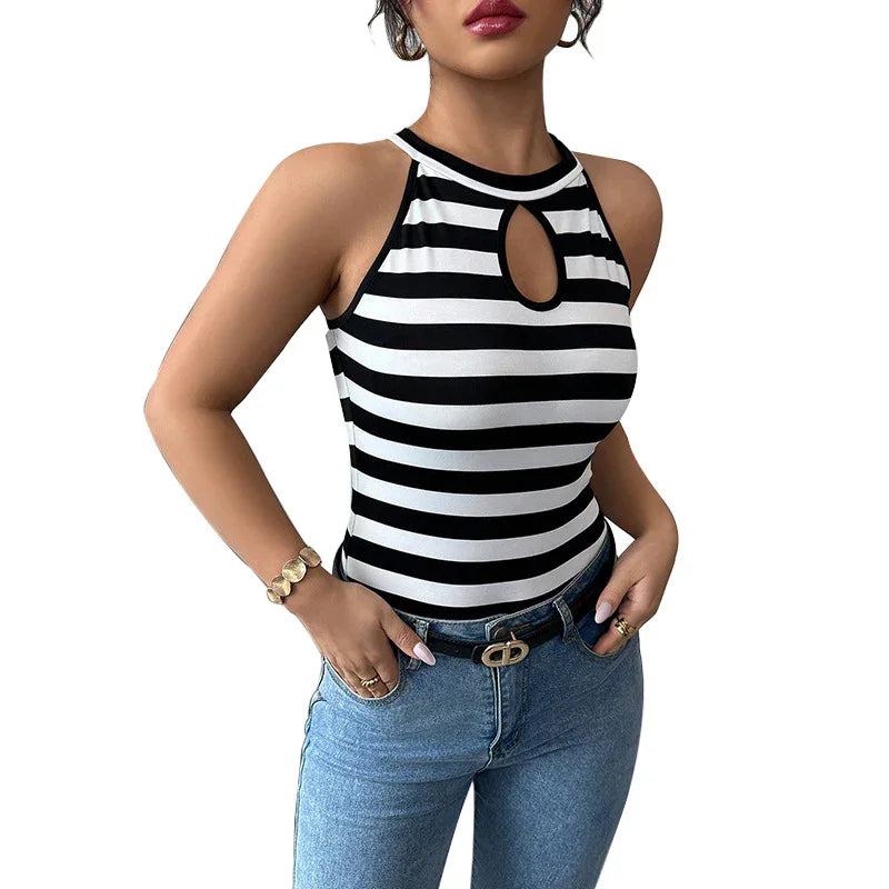 Woman wearing sleeveless black and white striped top with keyhole neckline and denim jeans