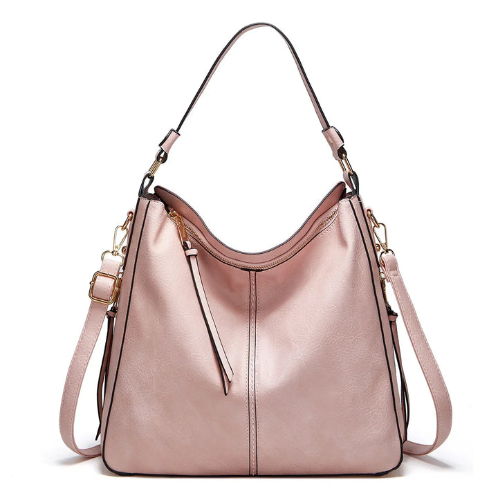 Elegant pink leather handbag with gold-tone hardware and adjustable shoulder strap