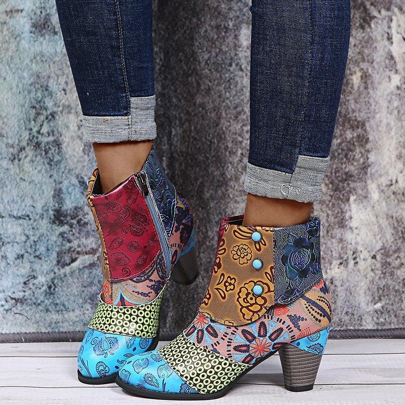 Colorful patchwork ankle boots with floral and geometric patterns worn with rolled-up dark jeans