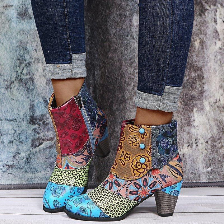 Colorful patchwork ankle boots with floral and geometric patterns worn with rolled-up dark jeans