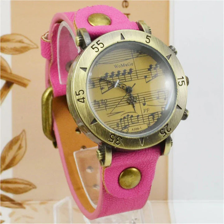 Vintage brass wristwatch with musical notes dial and pink leather strap with brass studs