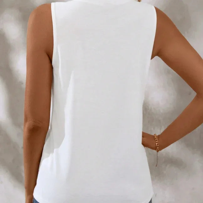 Back view of person wearing sleeveless white tank top against light textured wall