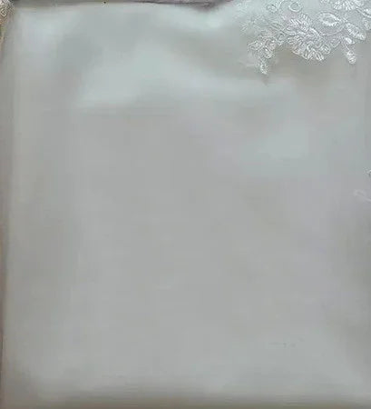 White satin pillowcase with delicate embroidered lace corner detailing