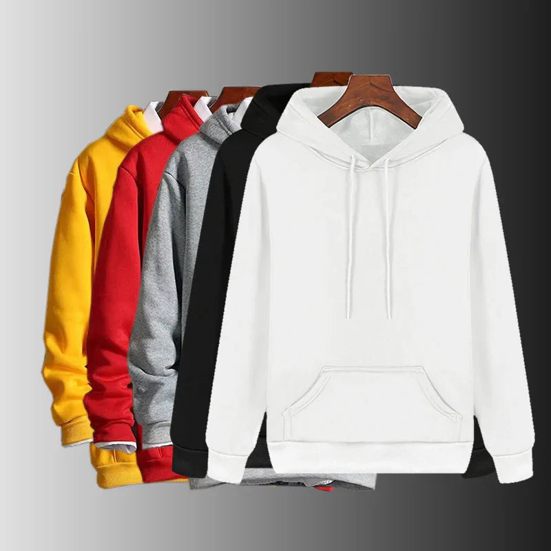 Set of plain hooded sweatshirts in white, black, gray, red, and yellow colors on wooden hangers