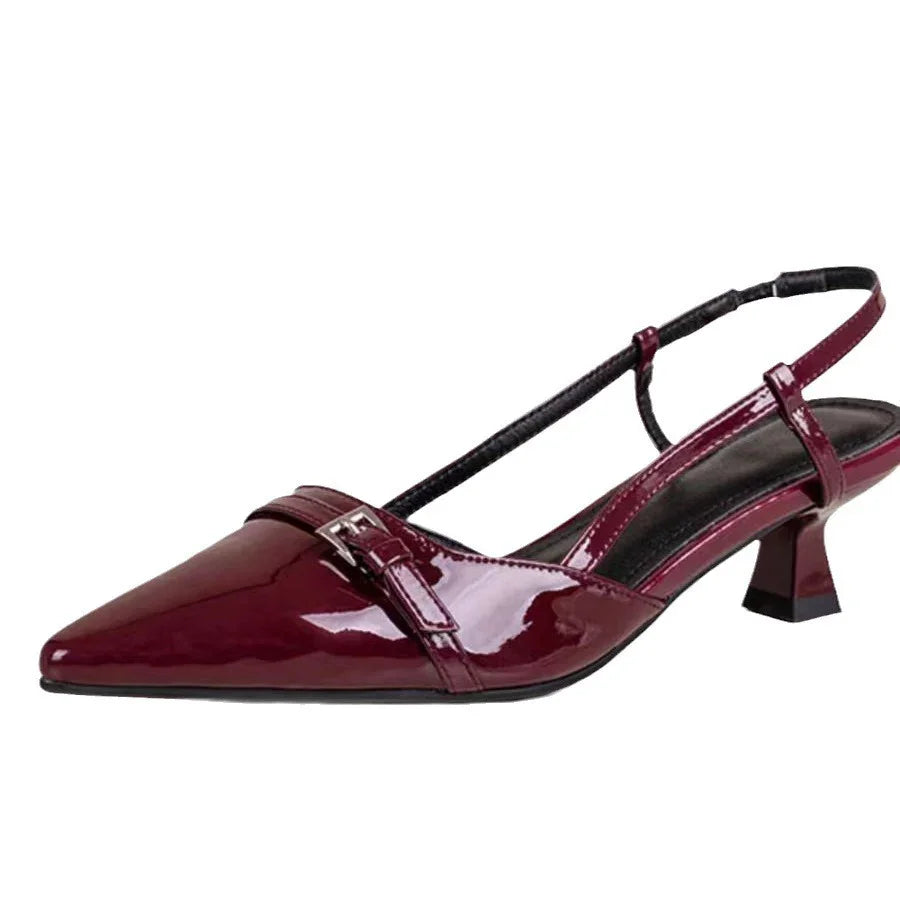 Glossy burgundy patent leather slingback kitten heel shoe with a pointed toe and buckle detail