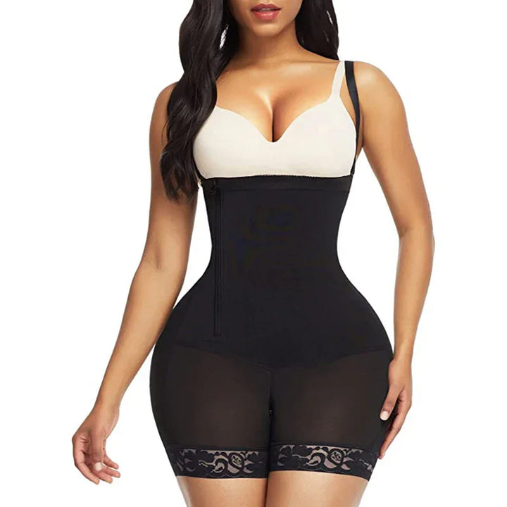 Woman wearing black waist trainer shapewear shorts with lace trim and beige bra