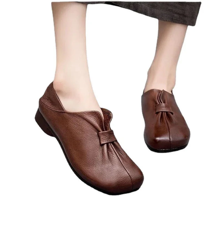 Brown leather slip-on women's shoes with gathered detailing and low black heels