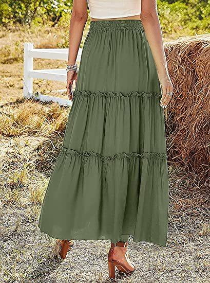 Woman wearing olive green tiered maxi skirt and brown heeled sandals outdoors near haystack