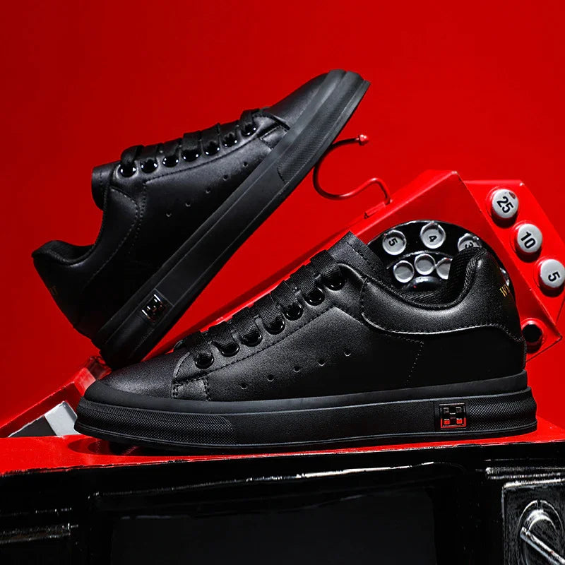 Black leather sneakers with black soles displayed on and above a vintage red rotary phone against a red background