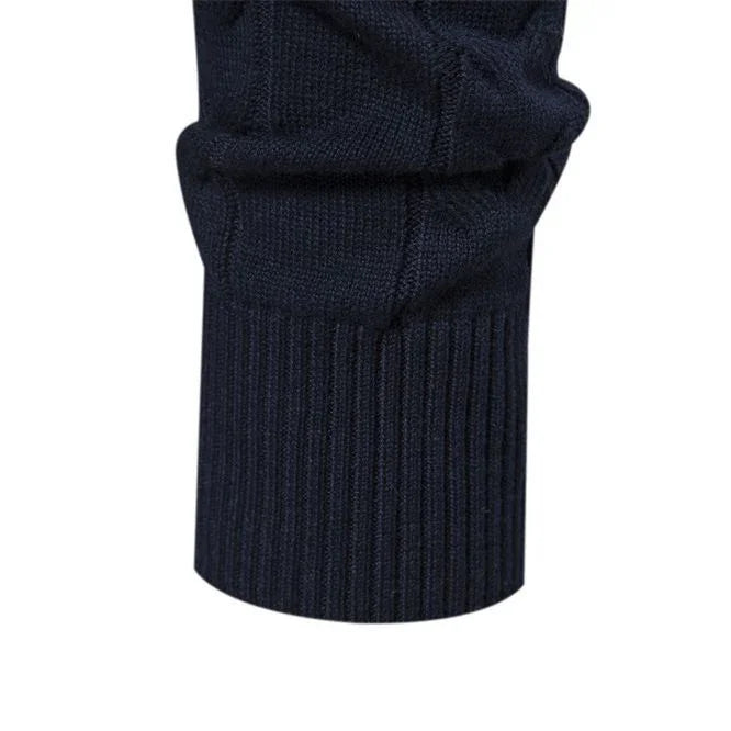Close-up of navy blue knitted sweater cuff with ribbed texture and detailed stitching