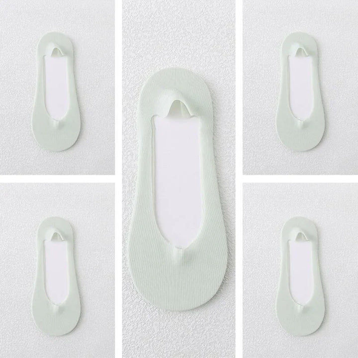 Light green no-show liner socks displayed on a white textured background