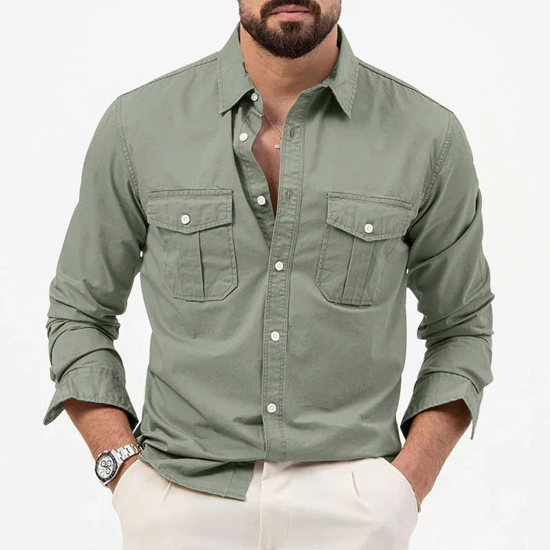 Man wearing olive green button-up shirt with chest pockets and beige pants, casual style