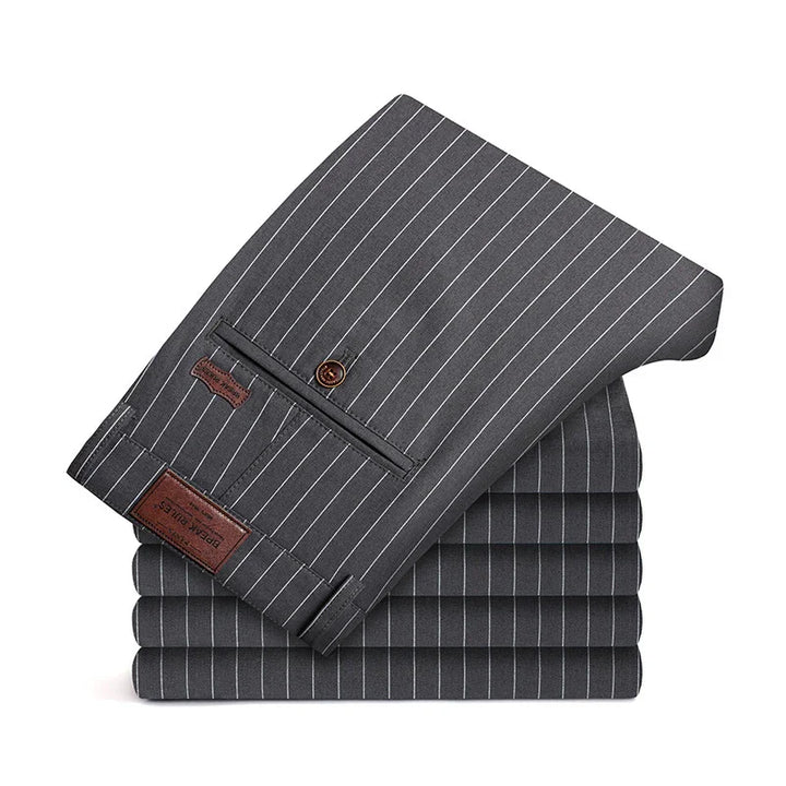 Stack of dark gray pinstripe formal trousers with button and leather label detail