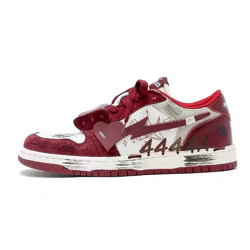 White and maroon Nike sneaker with graphic scribbles, heart-shaped tag, and worn sole design