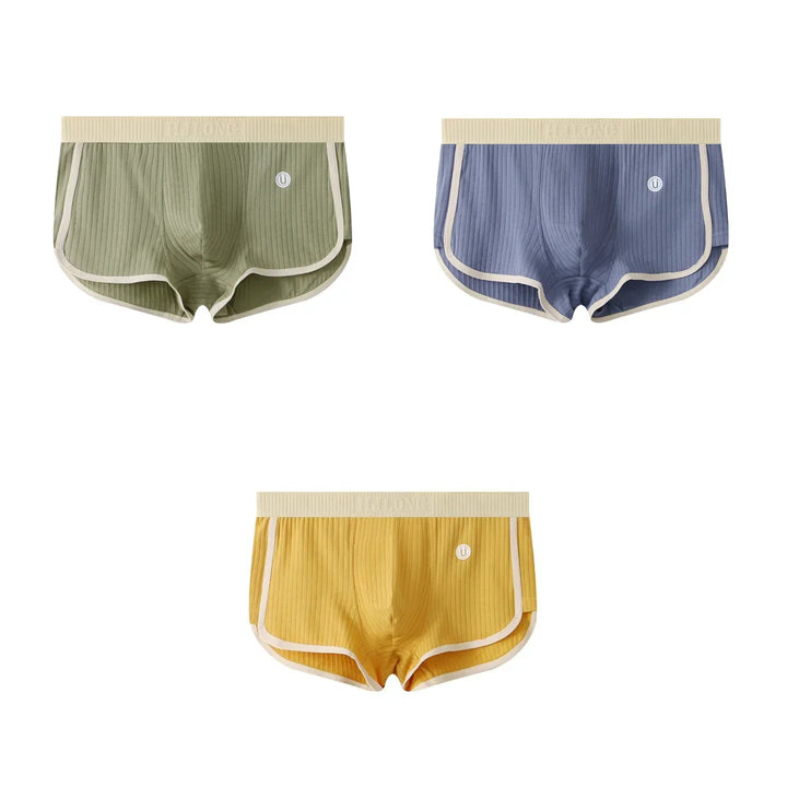Set of three ribbed men's boxer briefs in green, blue, and yellow with beige waistband and trim