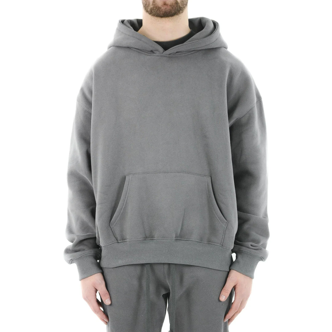 Man wearing plain gray oversized hoodie with kangaroo pocket and matching sweatpants