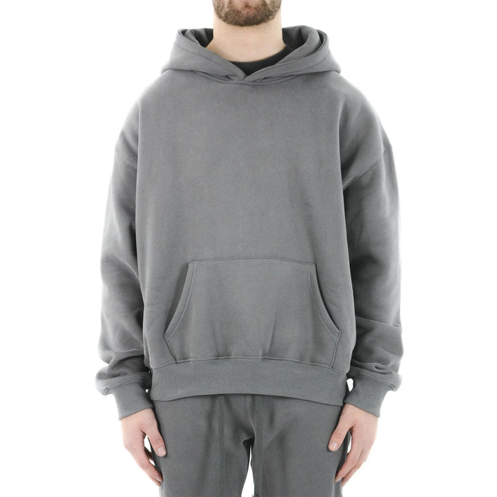 Man wearing plain gray oversized hoodie with kangaroo pocket and matching sweatpants