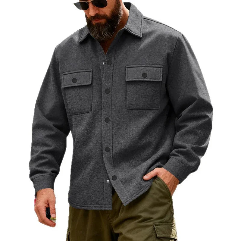 Man wearing dark gray button-up jacket with front chest pockets and olive cargo pants