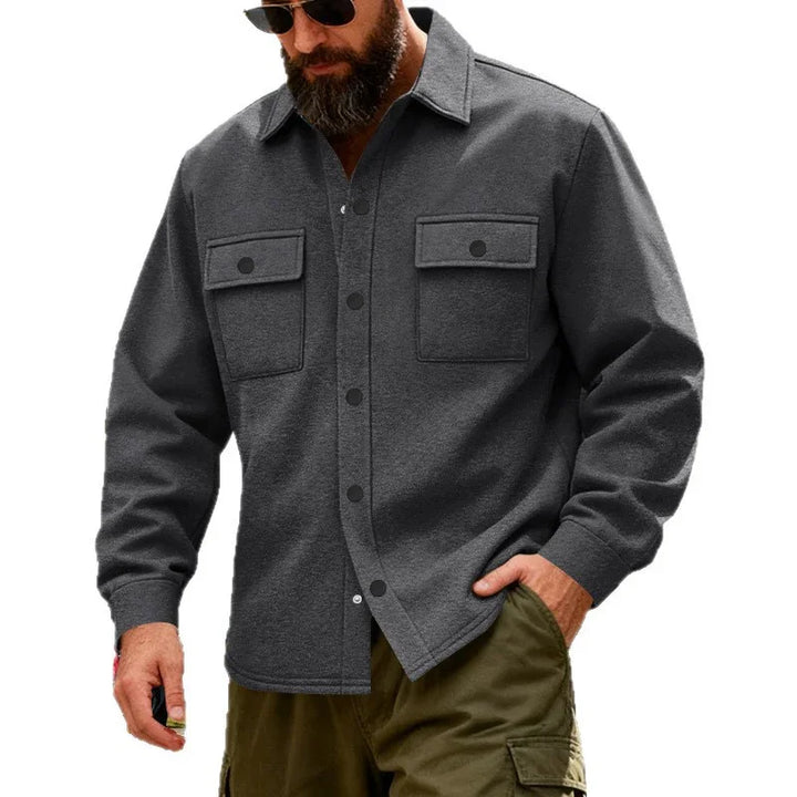 Man wearing dark gray button-up jacket with front chest pockets and olive cargo pants
