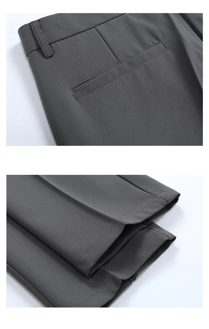 Close-up of dark gray dress pants showing back pocket and folded hems on white background
