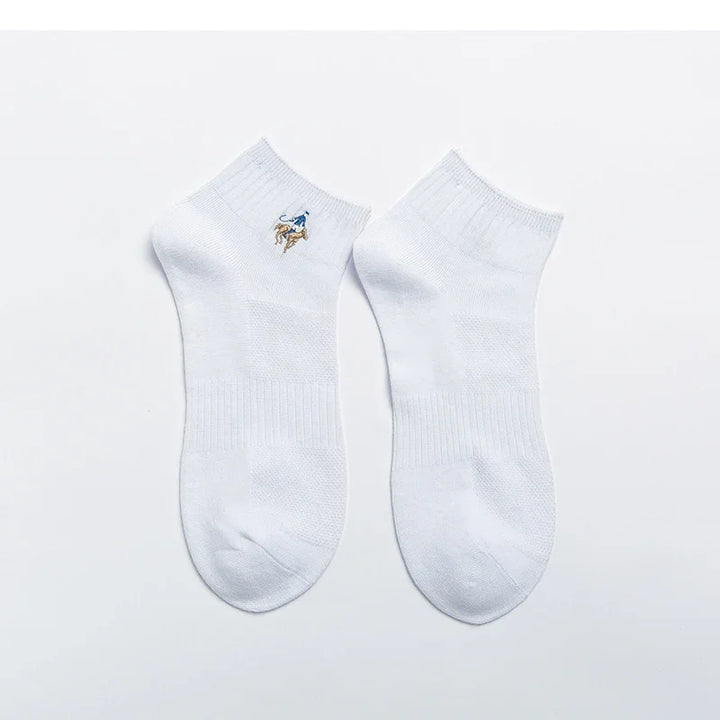 Pair of white ankle socks with embroidered blue and brown bear logo on one side