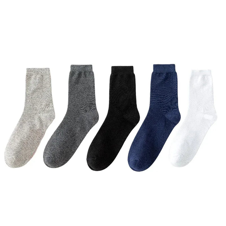 Set of five plain crew socks in beige, dark gray, black, navy blue, and white colors on white background