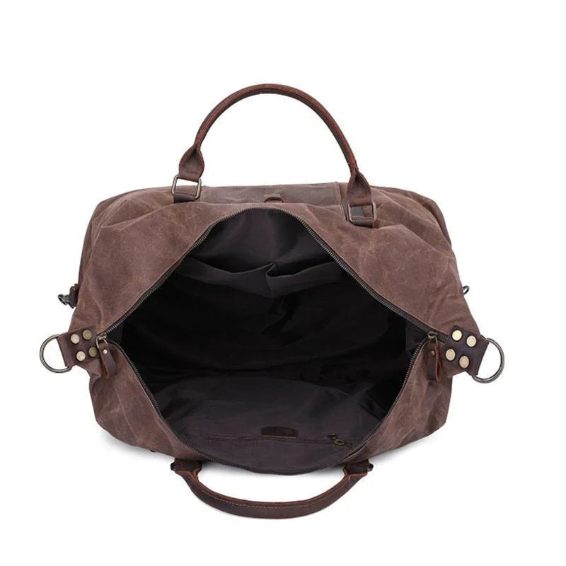 Open brown leather and canvas duffel bag with spacious black interior and sturdy handles