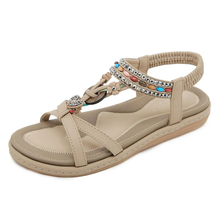 Beige flat sandal with colorful beads and silver studs on braided ankle strap