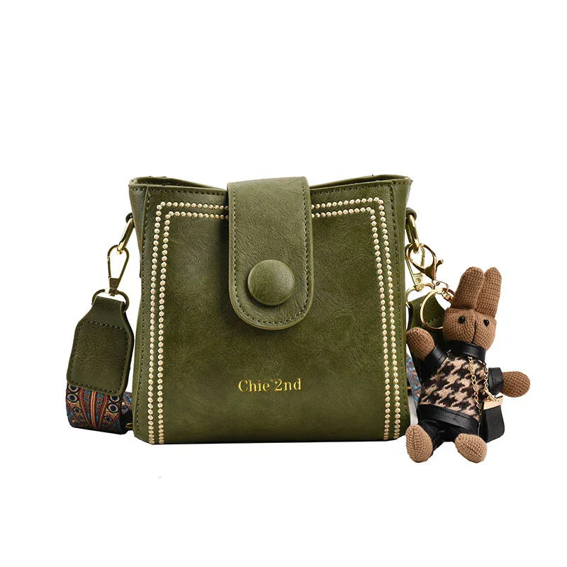 Olive green Chie 2nd crossbody bag with button flap and teddy bear keychain accessory