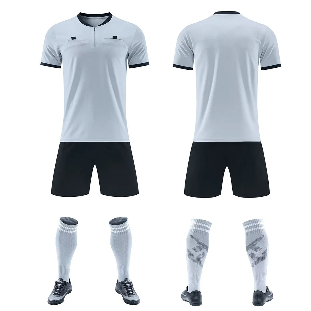 Front and back view of gray and black soccer uniform with matching socks and shoes on white background