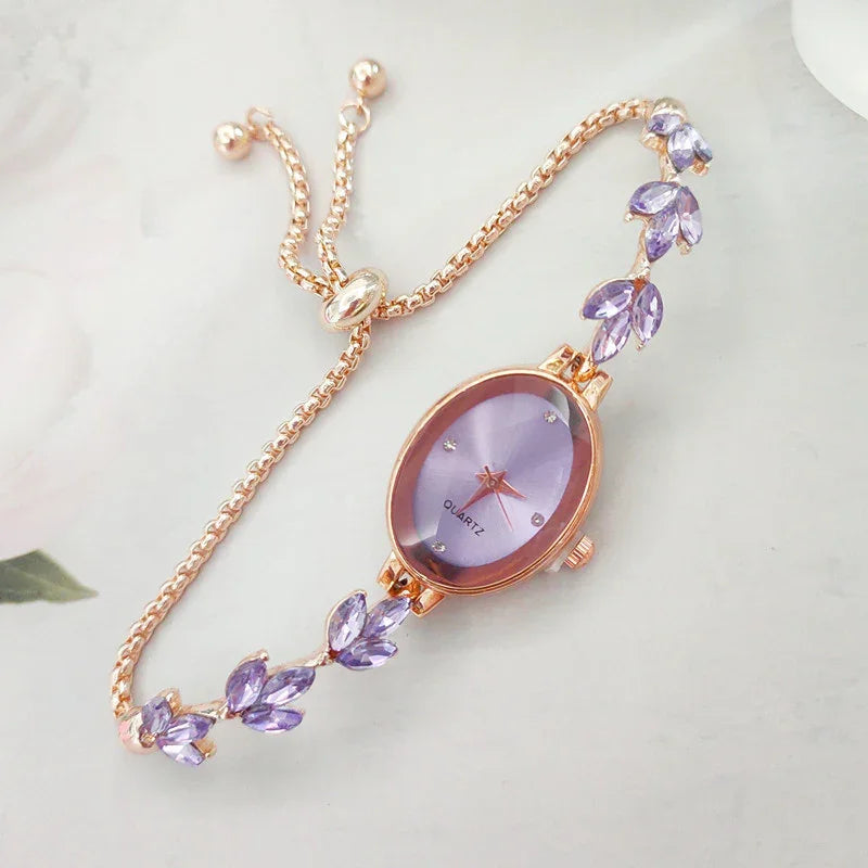 Elegant rose gold quartz wristwatch with purple crystal leaf accents and sliding clasp