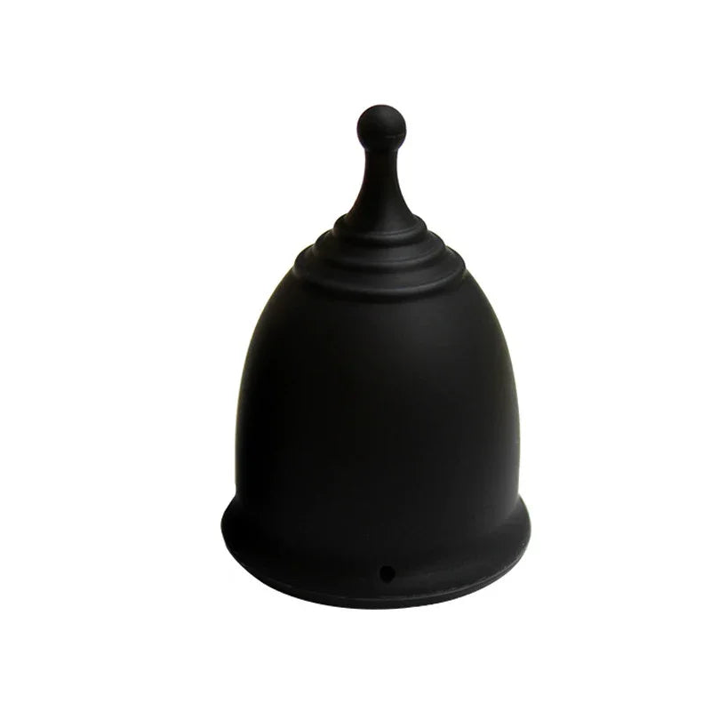 Black silicone menstrual cup with rounded base and stem on white background
