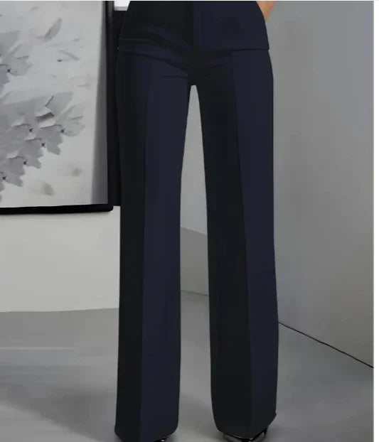 Woman wearing high-waisted black wide-leg trousers in modern minimalist setting