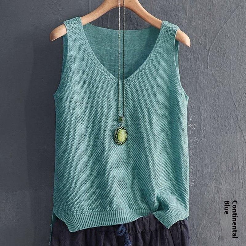 Continental blue sleeveless knitted tank top with V-neck on wooden hanger and pendant necklace
