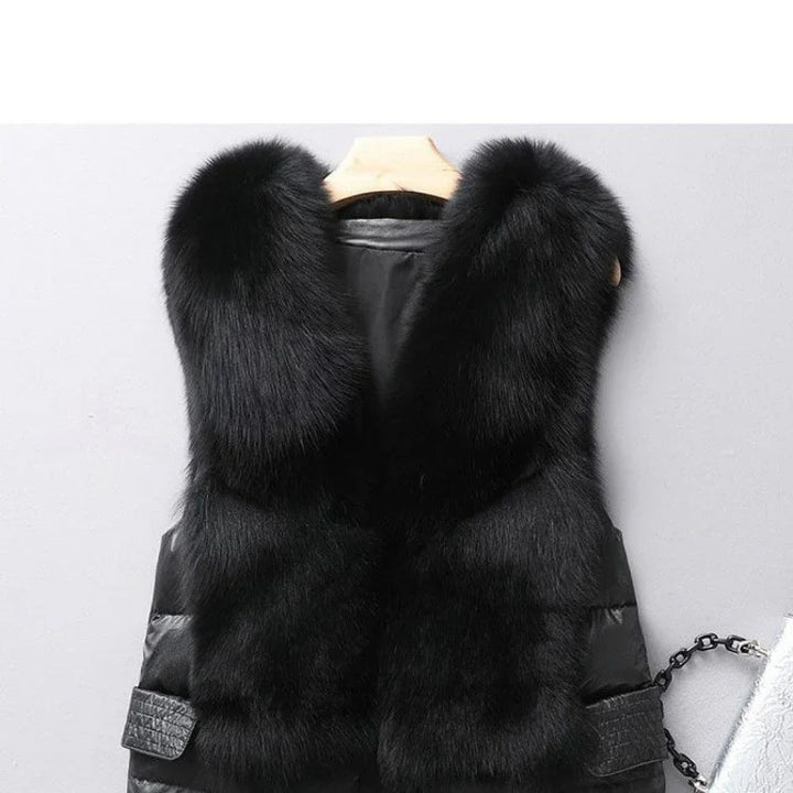 luxurious black fur vest with thick plush collar on wooden hanger against gray wall