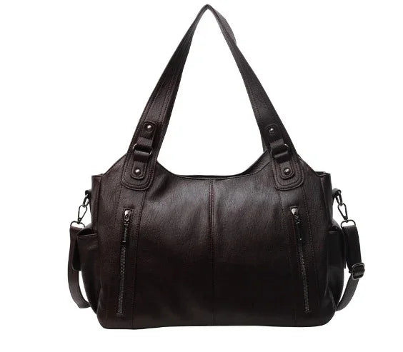 Black leather handbag with dual shoulder straps, front zipper pockets, and adjustable side strap