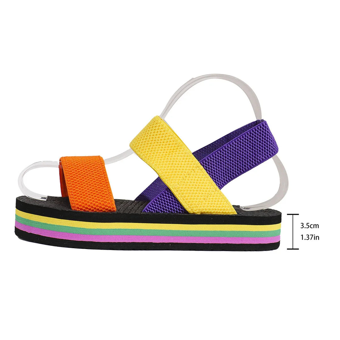 Colorful platform sandal with orange, yellow, and purple straps and striped sole on white background