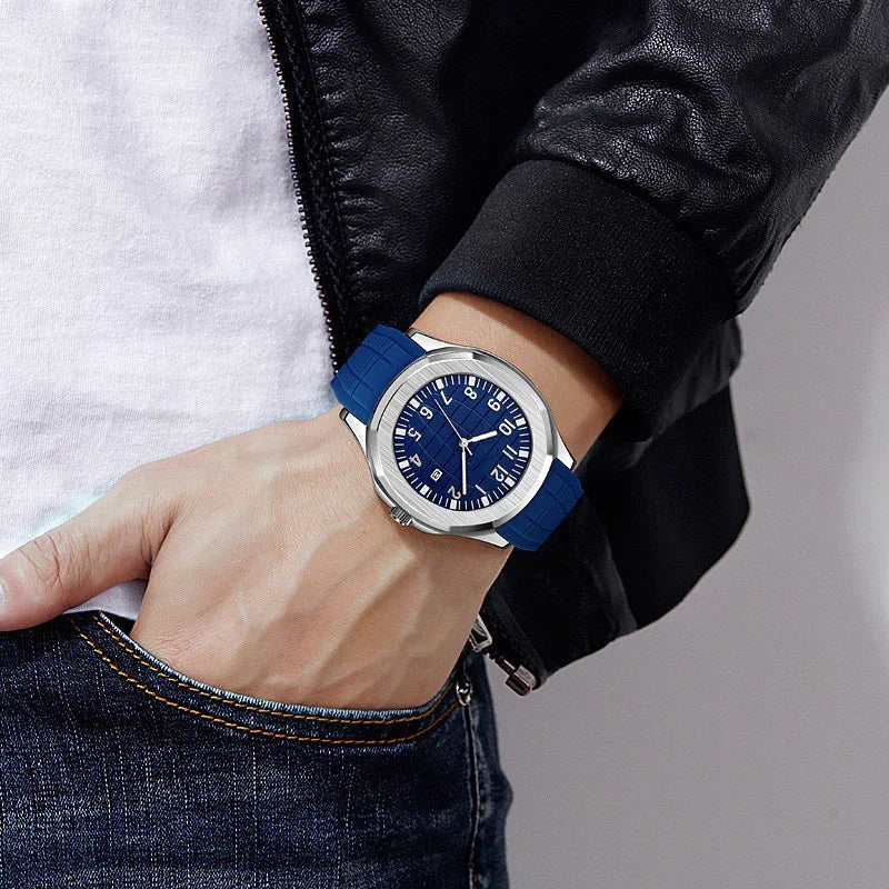 Close-up of wrist wearing a modern silver watch with blue dial and strap, paired with black leather jacket and jeans